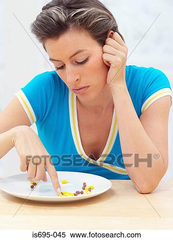 Woman with pills on a plate View Large Photo Image Stock Photography - Woman with pills on a plate. Fotosearch