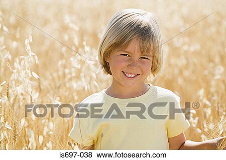 Boy in a wheat field View Large Photo Image Stock Photo - Boy in a wheat field. Fotosearch