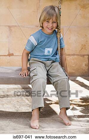 Stock Image - Boy on a swing. Fotosearch