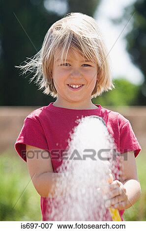 Stock Photo - Boy spraying water. Fotosearch