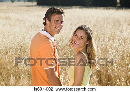 Stock Image - Couple in a field of wheat. Fotosearch