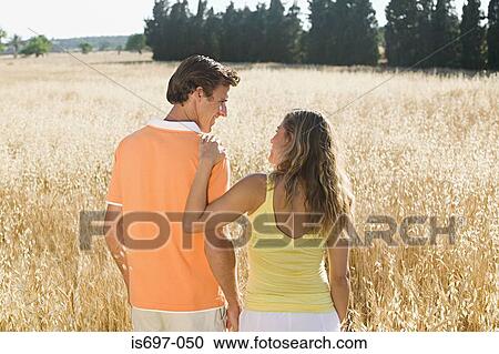 Couple in a field of wheat View Large Photo Image Stock Image - Couple in a field of wheat. Fotosearch