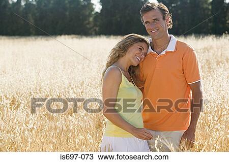 Couple in a field of wheat View Large Photo Image Stock Image - Couple in a field of wheat. Fotosearch