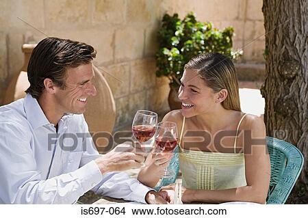 Couple toasting with red wine View Large Photo Image Picture - Couple toasting with red wine. Fotosearch
