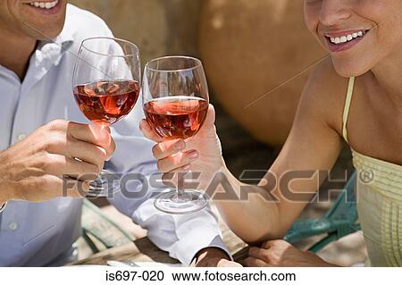 Couple toasting with wine View Large Photo Image Stock Image - Couple toasting with wine. Fotosearch