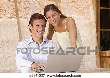 Couple using laptop computer View Large Photo Image Stock Photo - Couple using laptop computer. Fotosearch