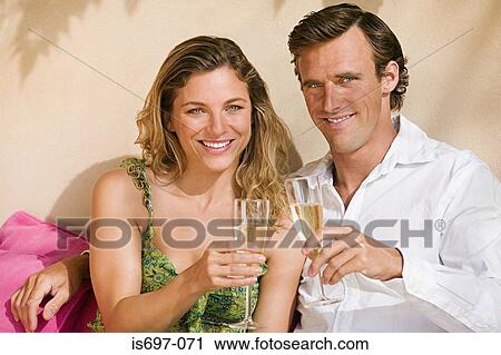 Stock Image - Couple with glasses of champagne. Fotosearch