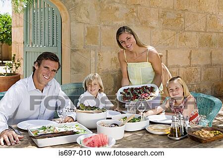 Family dining al fresco View Large Photo Image Stock Image - Family dining al fresco. Fotosearch