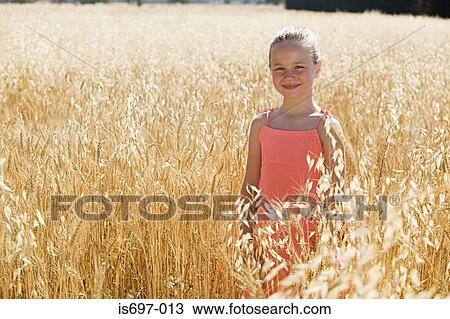 Girl in a field of wheat View Large Photo Image Stock Image - Girl in a field of wheat. Fotosearch