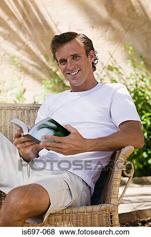 Man relaxing with a book View Large Photo Image Stock Photo - Man relaxing with a book. Fotosearch