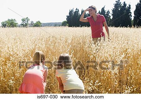 Mother and children playing hide and seek View Large Photo Image Stock Image - Mother and children playing hide and seek. Fotosearch