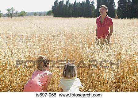 Mother and children playing hide and seek View Large Photo Image Stock Photography - Mother and children playing hide and seek. Fotosearch