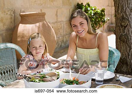 Mother and daughter dining al fresco View Large Photo Image Picture - Mother and daughter dining al fresco. Fotosearch
