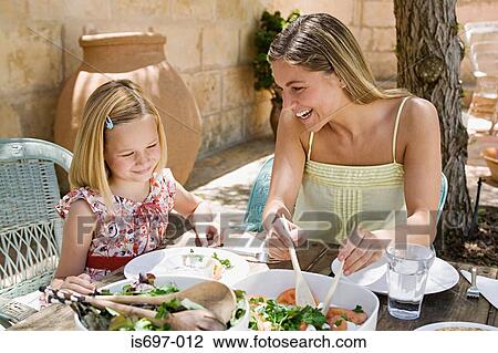 Mother and daughter dining al fresco View Large Photo Image Stock Image - Mother and daughter dining al fresco. Fotosearch