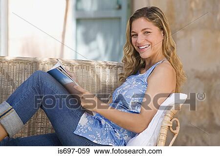 Woman with magazine View Large Photo Image Stock Photo - Woman with magazine. Fotosearch