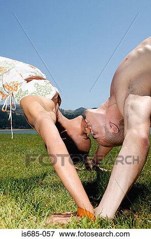 Couple bending over backwards to kiss View Large Photo Image Stock Photo - Couple bending over backwards to kiss. Fotosearch