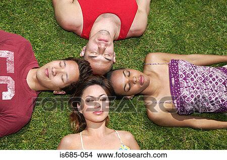 Picture - Friends lying on the grass. Fotosearch