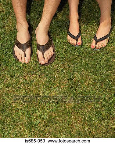Male and female feet in sandals View Large Photo Image Stock Photo - Male and female feet in sandals. Fotosearch