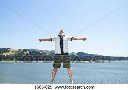 Stock Photography - Man by a lake. Fotosearch