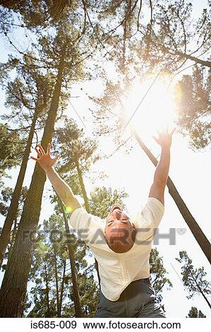 Man jumping backwards in a forest View Large Photo Image Stock Photo - Man jumping backwards in a forest. Fotosearch