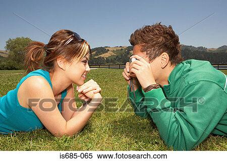 Stock Photography - Man taking a photograph of his girlfriend. Fotosearch