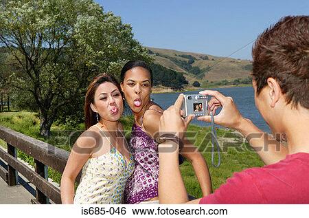 Man taking a picture of friends View Large Photo Image Stock Photograph - Man taking a picture of friends. Fotosearch