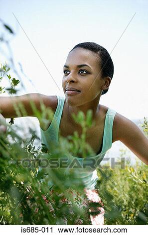 Woman amongst plants View Large Photo Image Stock Image - Woman amongst plants. Fotosearch