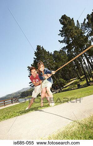 Young couple playing tug of war View Large Photo Image Stock Photography - Young couple playing tug of war. Fotosearch