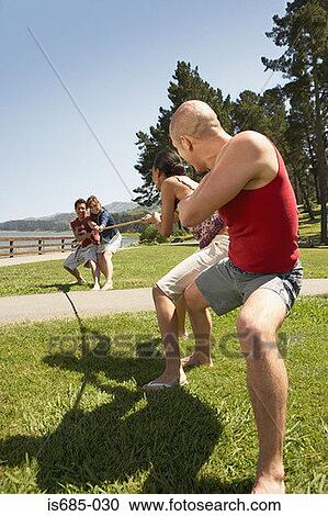 Young people playing tug of war View Large Photo Image Stock Image - Young people playing tug of war. Fotosearch