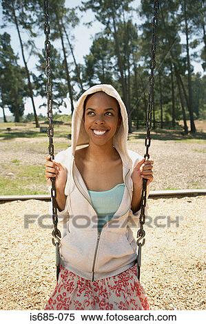 Young woman on a swing View Large Photo Image Stock Photography - Young woman on a swing. Fotosearch