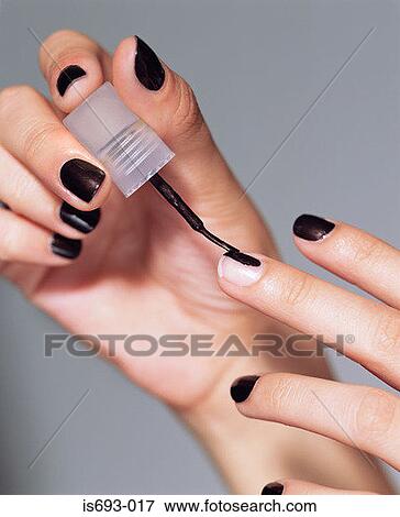 Painting fingernails View Large Photo Image Stock Photo - Painting fingernails. Fotosearch