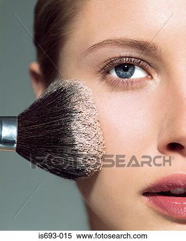 Stock Photography - Woman applying face powder. Fotosearch
