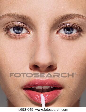 Woman applying lipgloss View Large Photo Image Stock Photo - Woman applying lipgloss. Fotosearch