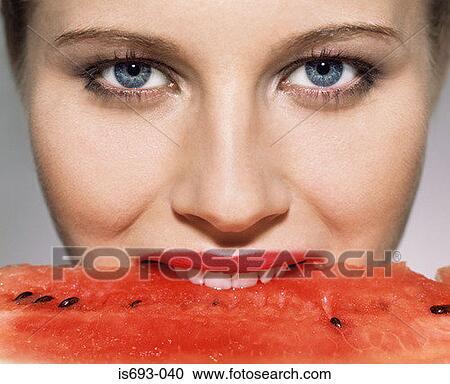 Woman biting into watermelon View Large Photo Image Stock Image - Woman biting into watermelon. Fotosearch