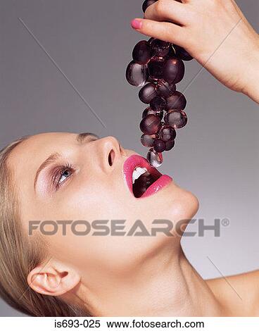 Woman eating glass grapes View Large Photo Image Stock Photography - Woman eating glass grapes. Fotosearch