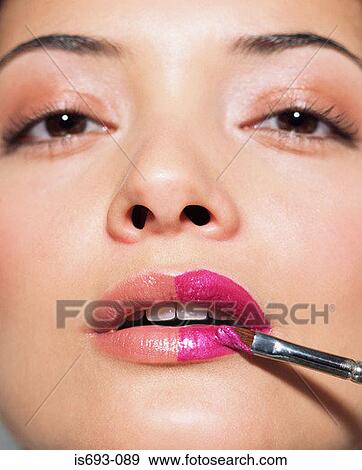 Stock Photo - Woman having her mouth painted. Fotosearch