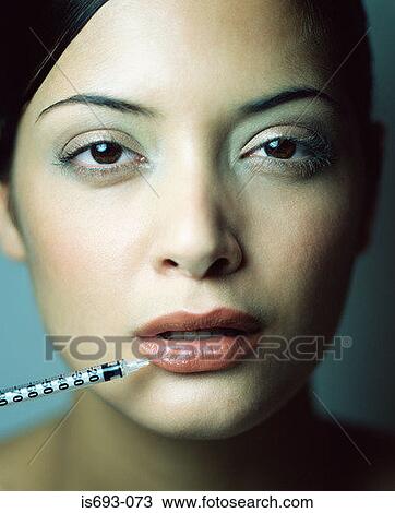 Woman having injection in her lip View Large Photo Image Stock Image - Woman having injection in her lip. Fotosearch