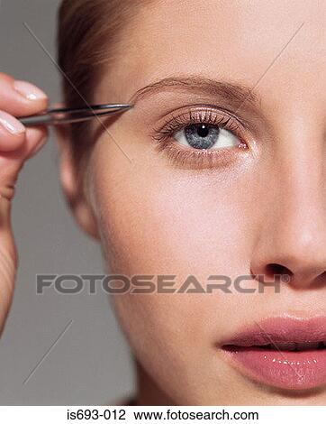 Woman plucking her eyebrow View Large Photo Image Stock Image - Woman plucking her eyebrow. Fotosearch
