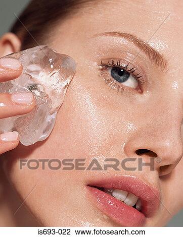 Woman putting ice on her face View Large Photo Image Stock Image - Woman putting ice on her face. Fotosearch