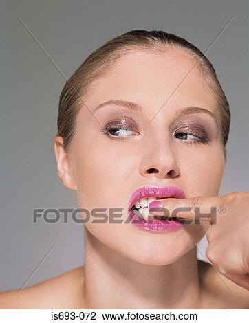 Woman rubbing her teeth View Large Photo Image Stock Image - Woman rubbing her teeth. Fotosearch