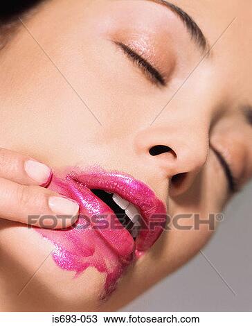 Woman smearing lipstick View Large Photo Image Stock Image - Woman smearing lipstick. Fotosearch
