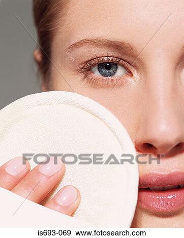 Stock Photo - Woman using loofah pad on her face. Fotosearch