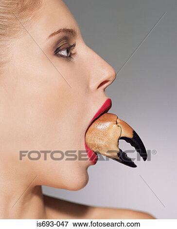 Woman with claw in her mouth View Large Photo Image Stock Photo - Woman with claw in her mouth. Fotosearch
