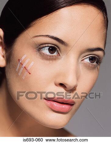 Woman with cut on her face View Large Photo Image Stock Image - Woman with cut on her face. Fotosearch