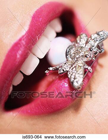Woman with insect brooch in her mouth View Large Photo Image Picture - Woman with insect brooch in her mouth. Fotosearch
