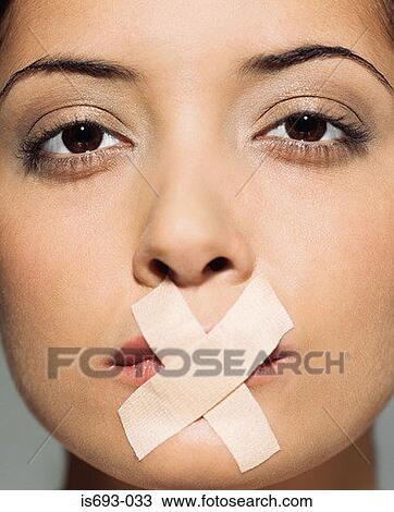 Woman with plasters over her mouth View Large Photo Image Stock Image - Woman with plasters over her mouth. Fotosearch