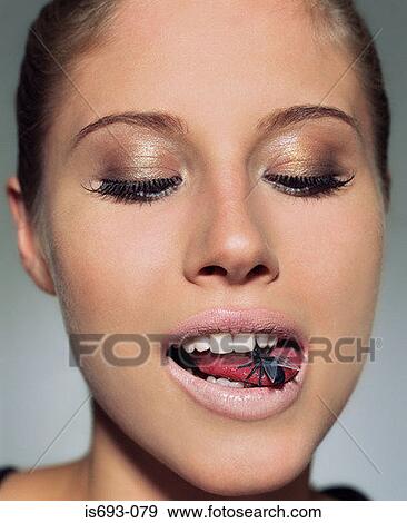 Woman with plastic fly in her mouth View Large Photo Image Stock Photo - Woman with plastic fly in her mouth. Fotosearch
