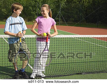 Girl and boy in a tennis court View Large Photo Image Stock Image - Girl and boy in a tennis court. Fotosearch