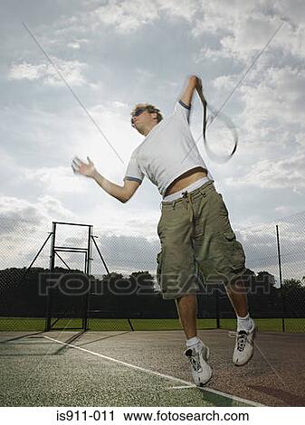 Stock Image - Man playing tennis. Fotosearch