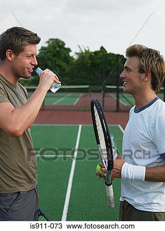 Stock Image - Men on a tennis court. Fotosearch